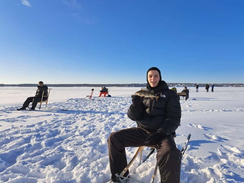 Lulea: Ice Fishing Tour in the heart of the city with Guide - Waiting on the ice, the warm reindeer fur setup